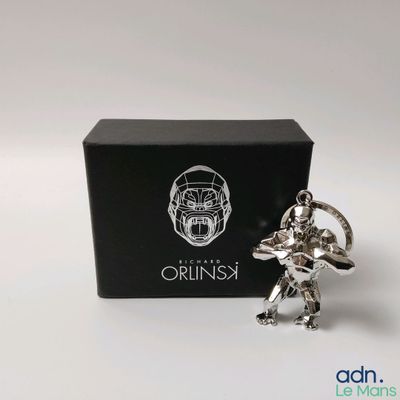 an image of a silver figurine of a man holding a sword