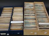 two boxes filled with files and papers sitting on top of a table