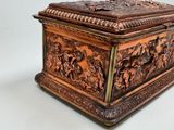 a wooden box with carvings on it sitting on a table