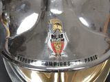a close up of a shiny motorcycle helmet with a badge on it