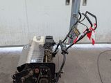 a small snow blower that is sitting on the ground