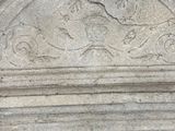 a stone bench with carvings on it in a room