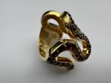 a close up of a gold ring on a white surface
