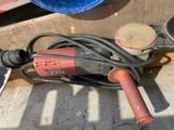someone is using a sander to sand a piece of wood
