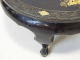 a black and gold table with a flower design on it