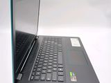 a black laptop with a blue keyboard on a white surface