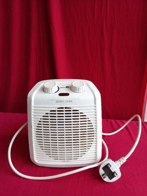 a white electric heater sitting on a red table