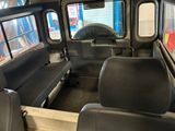 two seats in the back of a bus that is empty