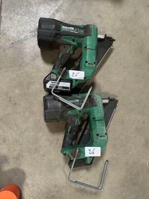 two electric tools are sitting on the floor next to a pair of orange cones