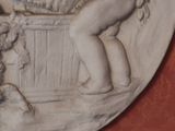 a relief of a boy and a dog in a basket
