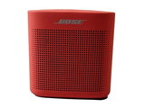 an image of a red bose bluetooth speaker on a white background