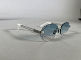 silver sunglasses with blue lenses on a white surface