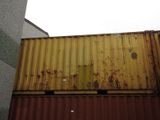 a rusted container sitting on top of a building