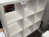 a white bookcase with a lot of shelves on it