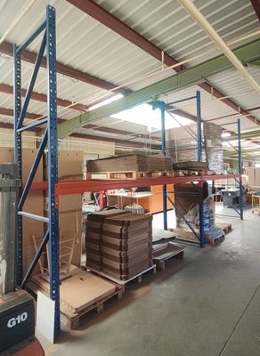 un grand entrepôt rempli de boîtes et de palettes