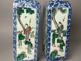 pair of chinese blue and white vases with figures on them