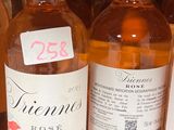 several bottles of wine are lined up on a shelf