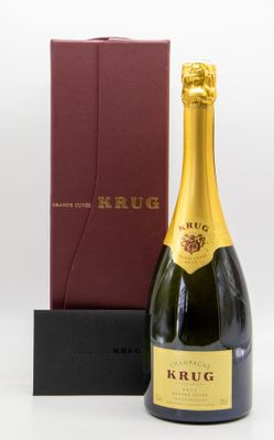 a bottle of krug champagne next to a red box
