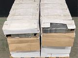 a stack of boxes on a pallet with a black wall in the background