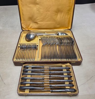 a lot of silverware in a case on a table