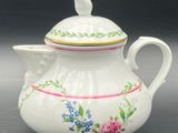 an image of a white tea pot with a bird on it