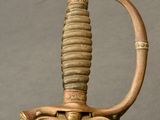 a close up of a sword with a handle on it