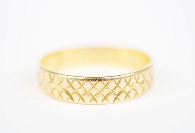 a close up of a gold ring on a white surface