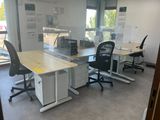an image of an office with two desks and two chairs