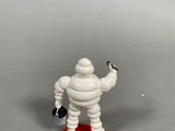 a toy figurine of a man with a bag of money