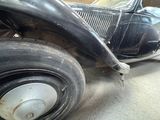 a black car that is parked in a garage
