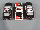 three toy cars that are lined up on a table
