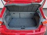 a trunk of a red car with its doors open