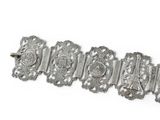 an image of a silver bracelet with a picture of a woman on it