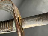 a close up of a sword with a metal handle