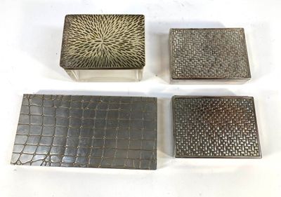 four pieces of metal are sitting on top of a white surface