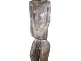a wooden statue of a man sitting on top of a black base