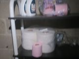 a shelf with toilet paper and a roll of toilet paper on it