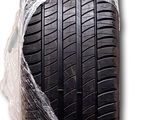 a tire wrapped in plastic on a white surface