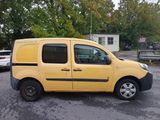 the small yellow van is parked in the parking lot