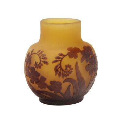 a yellow vase with a brown and white design on it