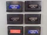 four nintendo game cartridges on the wall next to each other