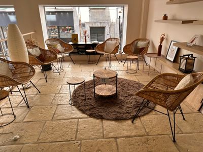 a living room with a lot of wicker chairs in it