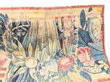 an image of a close up of a rug with a vase of flowers on it