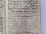 an old book with writing on it sitting on a table