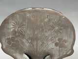 a silver vase with flowers in it on a stand