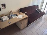 a couch and a desk in a living room