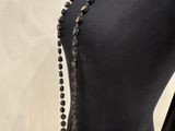a mannequin with black beads and a black purse on a mannequin mannequin mannequin mannequin mannequin mannequin mann