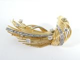 a close up of a gold and diamond broochle