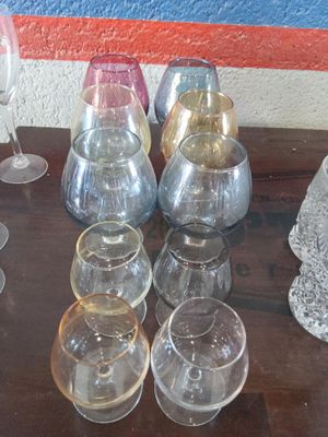 des bouteilles et des verres posés sur une table, avec un mur bleu en arrière-plan