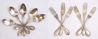 four different types of silver spoons and forks on a white surface